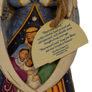 Early Jim Shore Heartwood Creek praying angel ornament with Nativity cloak. Rope hanger, approx. 4.5", c.2010–2012. Beautiful folk‑art Christmas collectible. Close up of tag.