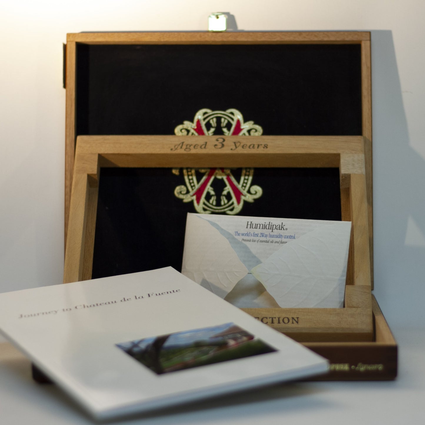 Gift for cigar connoisseur! CHATEAU de la FUENTE WOOD CIGAR BOX for FUENTE FUENTE OPUSX LANCERO cigars. Held 2006 limited-edition set containing 4 rare Fuente Fuente OpusX cigars, photo essay book, Journey to Chateau de la Fuente, and travel size Humidipak. Only 2,500 made and sold; box stamped 803 out of the 2500.