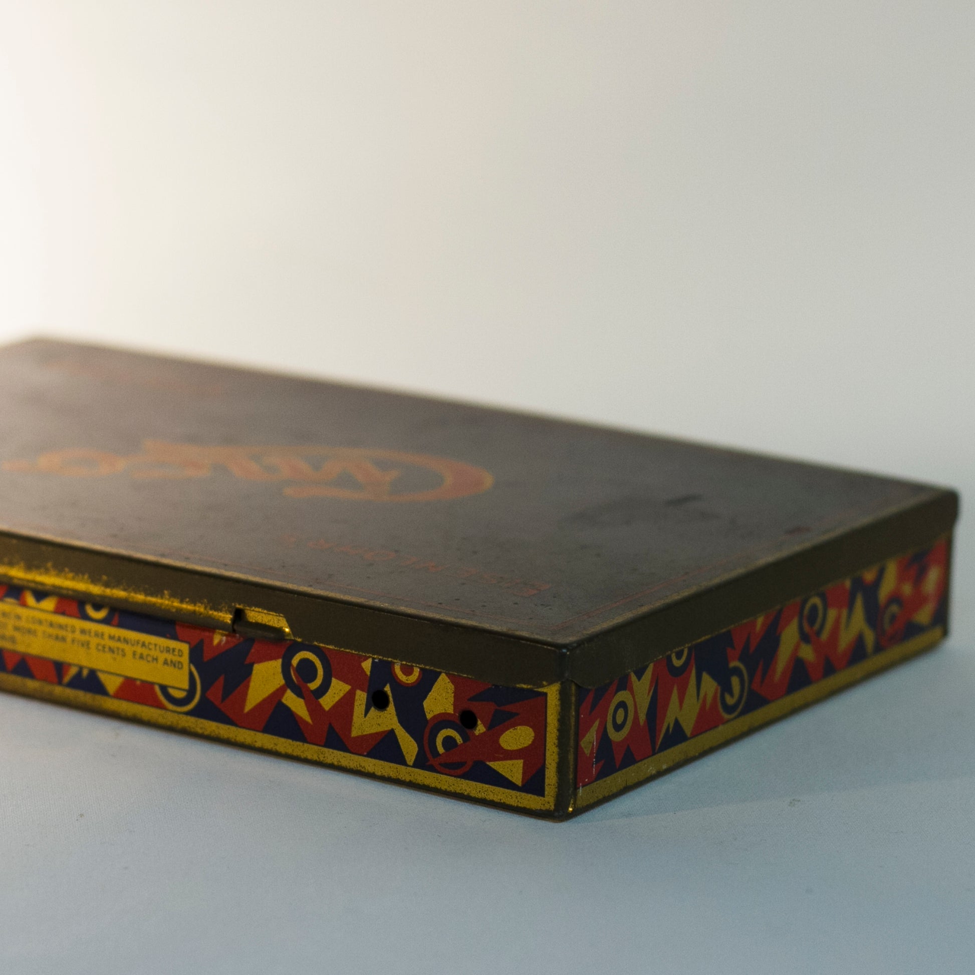 EISENLOHR'S CINCO CIGARS TIN is from the 1920s. Cinco was the chief product of the Philadelphia based cigar firm of Otto Eisenlohr and Brothers, a popular priced brand in the 1920s, producing and selling 210 million of the cigars. The brand was considered the largest individual seller of cigars in the United States.