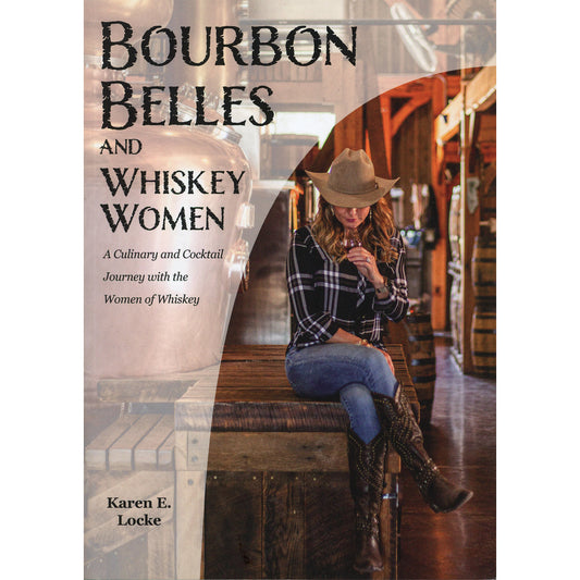 Book cover for 'Bourbon Belles and Whiskey Women' by Karen E. Locke, featuring a woman in a cowboy hat, plaid shirt, jeans, and boots sitting on a wooden crate inside a whiskey warehouse.
