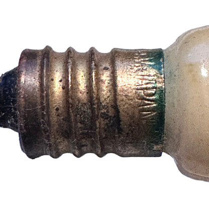 Unusual vintage Japanese figural Christmas light bulb shaped as corn in its husk. Molded glass, 14V C6-type base, 4½ inches, marked Japan. Close up of JAPAN mark.