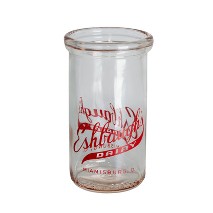 1940s Eshbaugh's Dairy glass jar from Miamisburg, Ohio. Red advertising, 12 oz capacity, and excellent vintage condition.