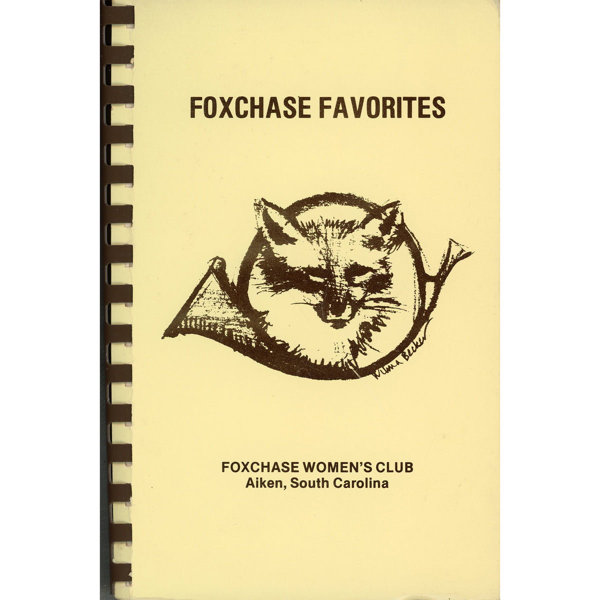A vintage spiral-bound cookbook cover titled 'FOXCHASE FAVORITES' with a black fox illustration and the text 'FOXCHASE WOMEN'S CLUB Aiken, South Carolina' on a pale yellow background.