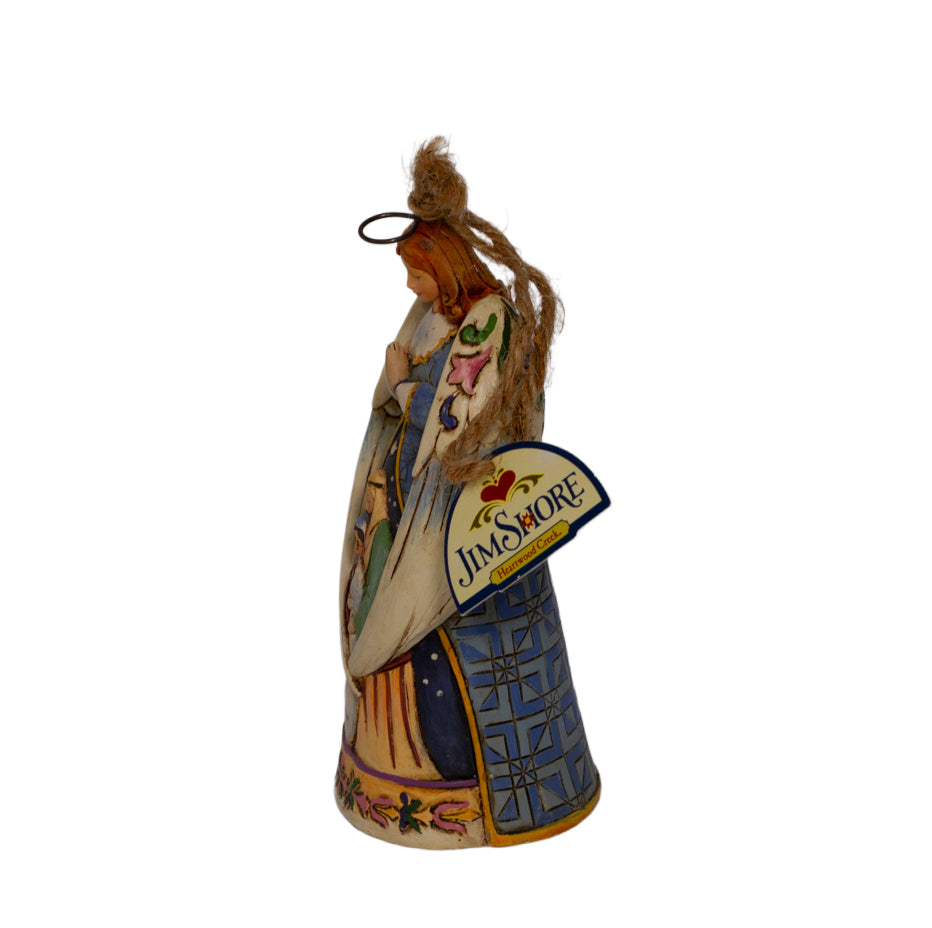 Early Jim Shore Heartwood Creek praying angel ornament with Nativity cloak. Rope hanger, approx. 4.5", c.2010–2012. Beautiful folk‑art Christmas collectible. Side view