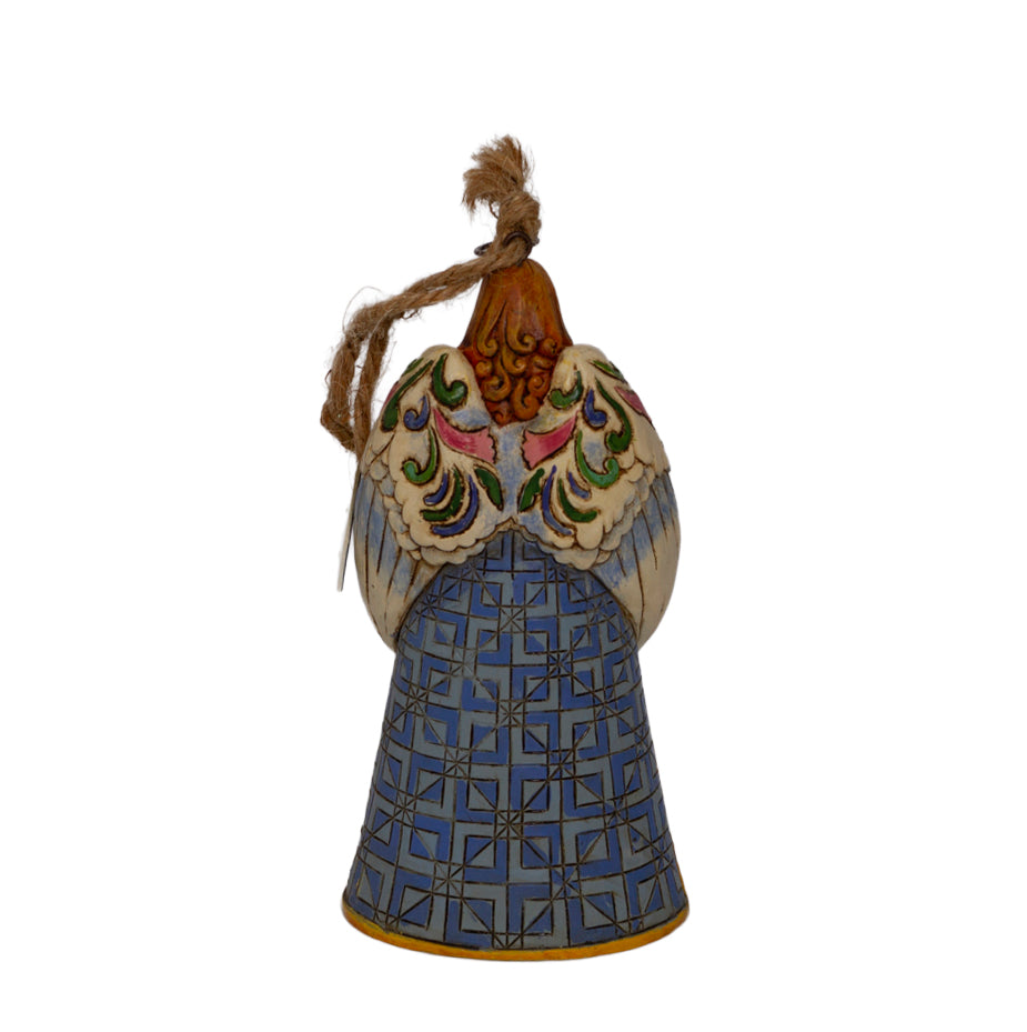 Early Jim Shore Heartwood Creek praying angel ornament with Nativity cloak. Rope hanger, approx. 4.5", c.2010–2012. Beautiful folk‑art Christmas collectible. Back view of quilt skirt