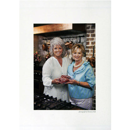 A photograph from Second Helpings by Johnnie Gabriel | Foreword by Paula Deen ©2010 Hardcover featuring author and Paula Dean standing in a kitchen.