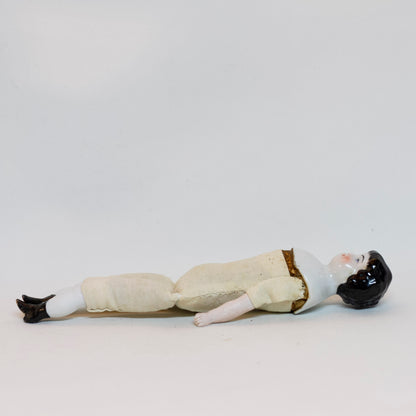 Antique CHINA SHOULDER DOLL HEAD DOLL 7 ¾” long; shoulder head measures 2" tall by 1 ⅝" wide at shoulders. Blue eyes, rosy cheeks, closed mouth and molded black curly hair with straight cut bangs. Bisque arms and legs, hand-sewn clean muslim body; stuffing appears original. No fractures. Likely German circa 1900. 