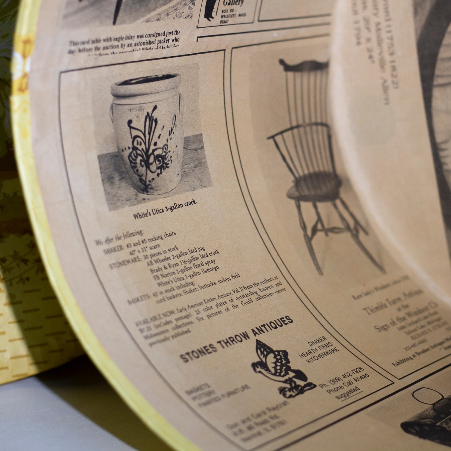 Reproduction of a "BRIDE'S BOX" made from slightly oval shaped large hat box covered in vintage yellow wallpaper featuring lambs and a Colonial girl. Inside and bottom papered with pages from the Maine Antique Digest, September 1977. Measures about 10" high by 15" in length by 13" wide.