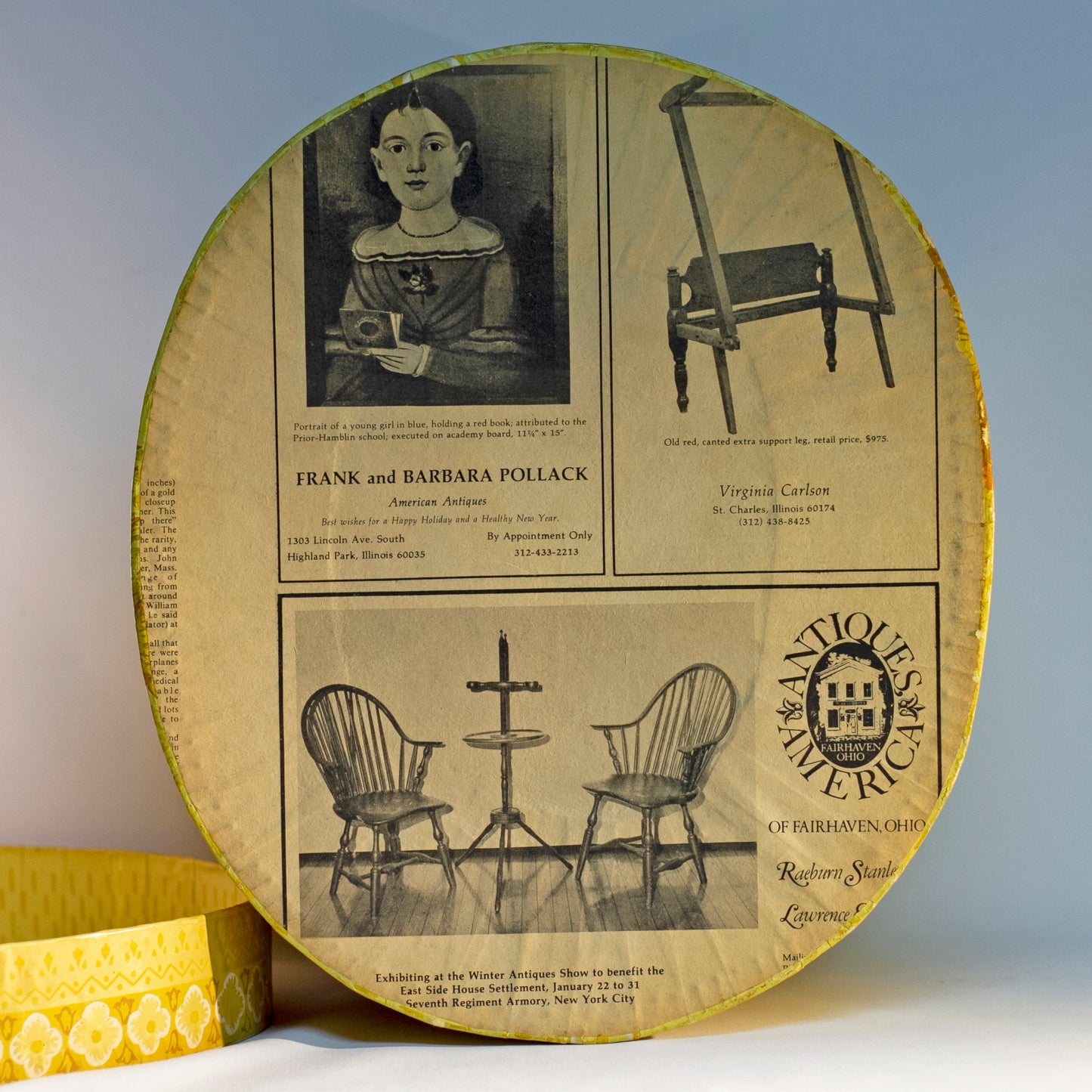 Reproduction of a "BRIDE'S BOX" made from slightly oval shaped large hat box covered in vintage yellow wallpaper featuring lambs and a Colonial girl. Inside and bottom papered with pages from the Maine Antique Digest, September 1977. Measures about 10" high by 15" in length by 13" wide.