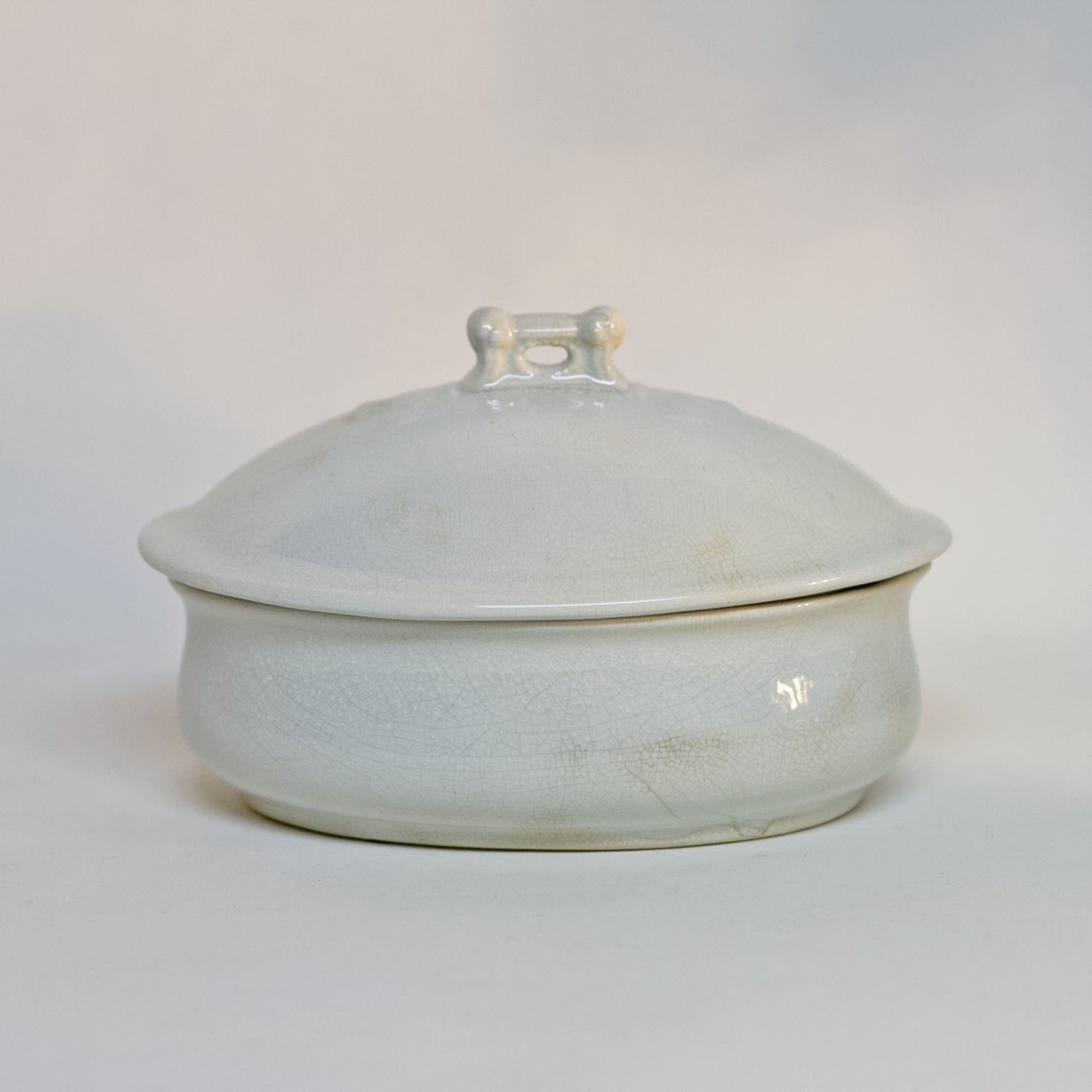 Gorgeous white antique IRONSTONE THREE-PIECE SOAP DISH made by MELLOR, TAYLOR AND COMPANY of Burslem Stoke-on-Tent in England. Set is in the shape of a small oval tureen and complete, including the drain and lid. Stamped dating the piece to between 1880-1904. Some staining, no chips.