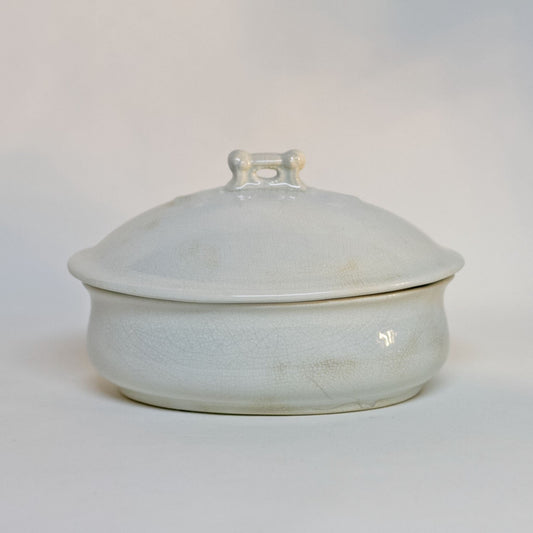 Gorgeous white antique IRONSTONE THREE-PIECE SOAP DISH made by MELLOR, TAYLOR AND COMPANY of Burslem Stoke-on-Tent in England. Set is in the shape of a small oval tureen and complete, including the drain and lid. Stamped dating the piece to between 1880-1904. Some staining, no chips.